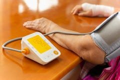 Senior woman checking blood pressure with monitor at home. royalty free stock image Senior woman checking blood pressure with monitor at home. royalty free stock image