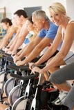 Senior Woman Cycling In Spinning Class