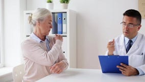 Senior woman and doctor meeting at hospital stock video footage Senior woman and doctor meeting at hospital stock video footage