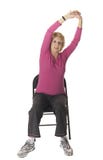 Senior woman doing stretch exercise in chair