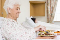 Senior Woman Eating Hospital Food stock image Senior Woman Eating Hospital Food stock image