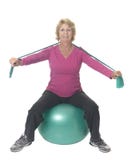 Senior woman on exercise ball with resistance band stock photos Senior woman on exercise ball with resistance band stock photos