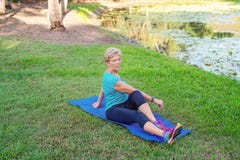 Senior Female Doing Stretching Exercises In Garden stock image Senior Female Doing Stretching Exercises In Garden stock image