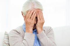 Senior woman suffering from headache or grief stock image Senior woman suffering from headache or grief stock image