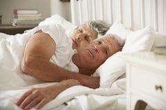 Senior Woman Tries To Be Affectionate Towards Husband In Bed royalty free stock images Senior Woman Tries To Be Affectionate Towards Husband In Bed royalty free stock images