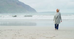 Senior woman walking on beach