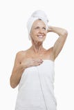 Senior woman wrapped in towels against white background Royalty Free Stock Image Senior woman wrapped in towels against white background Royalty Free Stock Image