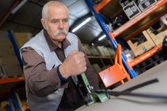 Senior worker using old lathe stock images Senior worker using old lathe stock images