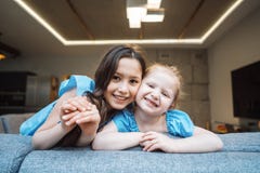 Senior and younger daughter on the big couch royalty free stock images Senior and younger daughter on the big couch royalty free stock images
