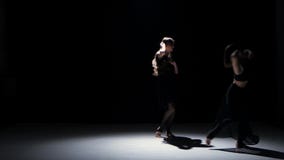 Sensual contemporary dance performance of four dancers on black, shadow stock footage Sensual contemporary dance performance of four dancers on black, shadow stock footage