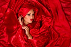 Sensual Face In Red Satin Fabric Royalty Free Stock Photography