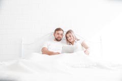 Sensueel jong paar samen in bed Gelukkig paar in slaapkamer op een witte achtergrond stock afbeelding Sensueel jong paar samen in bed Gelukkig paar in slaapkamer op een witte achtergrond stock afbeelding