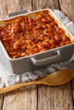 Serbian food: prebranac baked beans with onion close-up in baking dish. vertical stock photos Serbian food: prebranac baked beans with onion close-up in baking dish. vertical stock photos