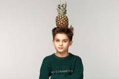 Serious boy teenager in green sweater posing in studio royalty free stock photography Serious boy teenager in green sweater posing in studio royalty free stock photography