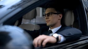 Serious business man sitting in car, waiting in traffic jam, transportation stock photo Serious business man sitting in car, waiting in traffic jam, transportation stock photo