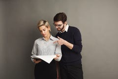 Serious couple in formal clothes on gray background Royalty Free Stock Images Serious couple in formal clothes on gray background Royalty Free Stock Images