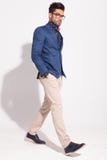 Serious elegant man with hands in pockets walking royalty free stock photo Serious elegant man with hands in pockets walking royalty free stock photo