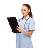 Serious female doctor or nurse with stethoscope stock photo Serious female doctor or nurse with stethoscope stock photo