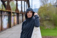 Serious thoughtful woman standing on an old bridge Stock Image Serious thoughtful woman standing on an old bridge Stock Image