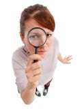 Serious woman as detective with magnifier