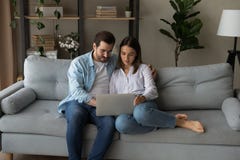 Serious young couple holding laptop consider on wedding planning