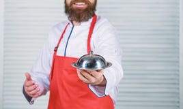 Serve food. Cuisine culinary. man holds kitchen dish tray in restaurant. Healthy food cooking. Mature hipster with beard royalty free stock image Serve food. Cuisine culinary. man holds kitchen dish tray in restaurant. Healthy food cooking. Mature hipster with beard royalty free stock image
