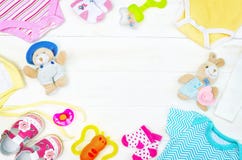 Set of clothing and items for a newborn baby placed on board royalty free stock images Set of clothing and items for a newborn baby placed on board royalty free stock images
