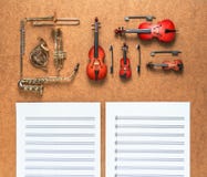 Set of five golden brass wind and four string musical orchestra instruments and sheet music lying near it. Music concept. Royalty Free Stock Photos Set of five golden brass wind and four string musical orchestra instruments and sheet music lying near it. Music concept. Royalty Free Stock Photos