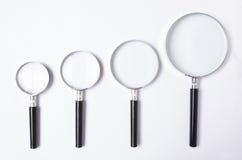 Many sizes of magnifying glass on white table,top view stock image Many sizes of magnifying glass on white table,top view stock image