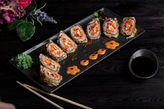 Set sushi rolls on a black rectangular plate on a dark background stock image Set sushi rolls on a black rectangular plate on a dark background stock image