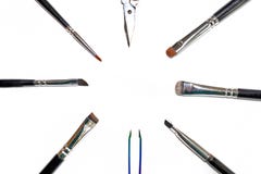 Set tools make-up artist. Isolated set of different makeup artist brushes and scissors lie in a circle with copyspace stock images Set tools make-up artist. Isolated set of different makeup artist brushes and scissors lie in a circle with copyspace stock images