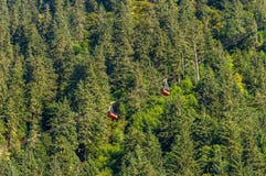 14 settembre 2018 - Juneau, Alaska: Due automobili ed alberi rossi di Robert Tramway del supporto fotografia stock 14 settembre 2018 - Juneau, Alaska: Due automobili ed alberi rossi di Robert Tramway del supporto fotografia stock