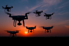 Silhouette of drones in the sky, orange sunset stock photo Silhouette of drones in the sky, orange sunset stock photo