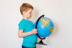 Seven-year-old Caucasian boy holding a large globe stock image Seven-year-old Caucasian boy holding a large globe stock image