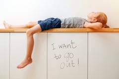 Seven Year Old Looking At The Ceiling, Lying In Boredom And Frustration Royalty Free Stock Photos