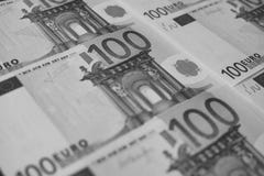 Several banknotes of 100 euros close-up, monochrome royalty free stock image Several banknotes of 100 euros close-up, monochrome royalty free stock image