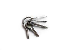 Several keys on a white isolated background,the keys to the apartment stock photo Several keys on a white isolated background,the keys to the apartment stock photo