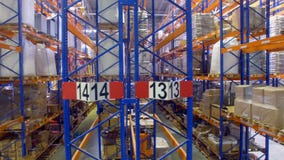 Several half-full warehouse rack rows in a front view. stock video footage Several half-full warehouse rack rows in a front view. stock video footage