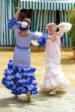 Women dressed in colourful flamenco dresses and dancing at the Seville April Fair. stock image Women dressed in colourful flamenco dresses and dancing at the Seville April Fair. stock image