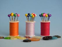 Sewing thread spools, buttons and sewing pins: many colors, a joyful combination. royalty free stock photo Sewing thread spools, buttons and sewing pins: many colors, a joyful combination. royalty free stock photo