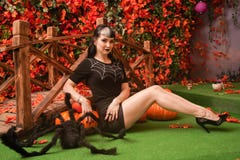 Sexy And Attractive Brunette Witch In Autumn Colorful Park With Orange And Red Leaves Posing With Pumpkins Royalty Free Stock Images