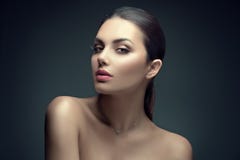 Sexy beauty brunette woman with perfect makeup. Beauty girl`s face on dark background