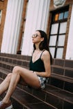 Sexy girl in sunglasses t-shirt and short shorts near the columns stock photos Sexy girl in sunglasses t-shirt and short shorts near the columns stock photos