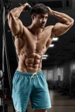 Sexy muscular man working out in gym doing exercises, strong male naked torso abs Stock Image Sexy muscular man working out in gym doing exercises, strong male naked torso abs Stock Image