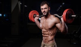 strong bodybuilder athletic men pumping up muscles with dum royalty free stock images strong bodybuilder athletic men pumping up muscles with dum royalty free stock images