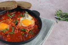 Shakshuka is a traditional oriental dish of eggs, fresh tomatoes, garlic, spices, olive oil and herbs. stock photos Shakshuka is a traditional oriental dish of eggs, fresh tomatoes, garlic, spices, olive oil and herbs. stock photos