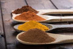 Spices and herbs in wood spoons over wooden background Stock Photos Spices and herbs in wood spoons over wooden background Stock Photos