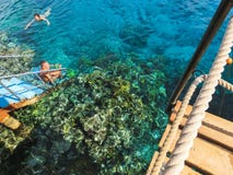 Sharm El Sheikh, Egypt - December 31, 2018: The people snorkeling in blue waters above coral reef on red sea in Sharm El royalty free stock photography Sharm El Sheikh, Egypt - December 31, 2018: The people snorkeling in blue waters above coral reef on red sea in Sharm El royalty free stock photography