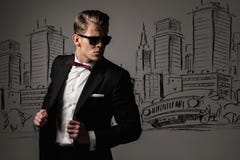 Sharp dressed man in black suit against city Stock Image Sharp dressed man in black suit against city Stock Image