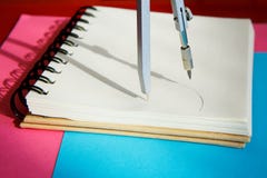 Sharpened colored pencils lie together with a blank notepad on a blue background stock image Sharpened colored pencils lie together with a blank notepad on a blue background stock image